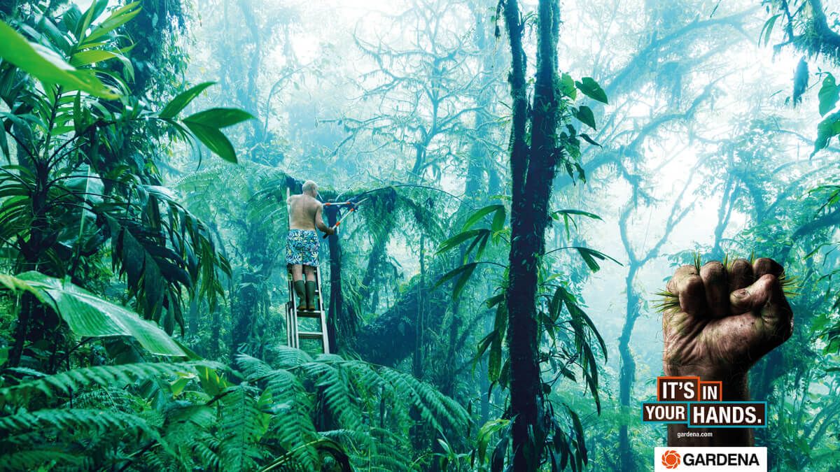 Advertising poster for Gardena gardening tools showing a man cutting the jungle